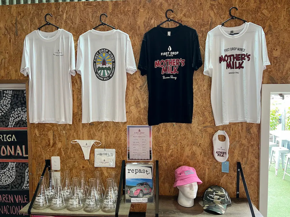 First Drop Wines full merch range on a wall.